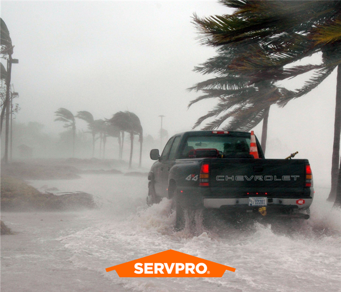 A Chevrolet truck drives through extreme hurricane conditions.