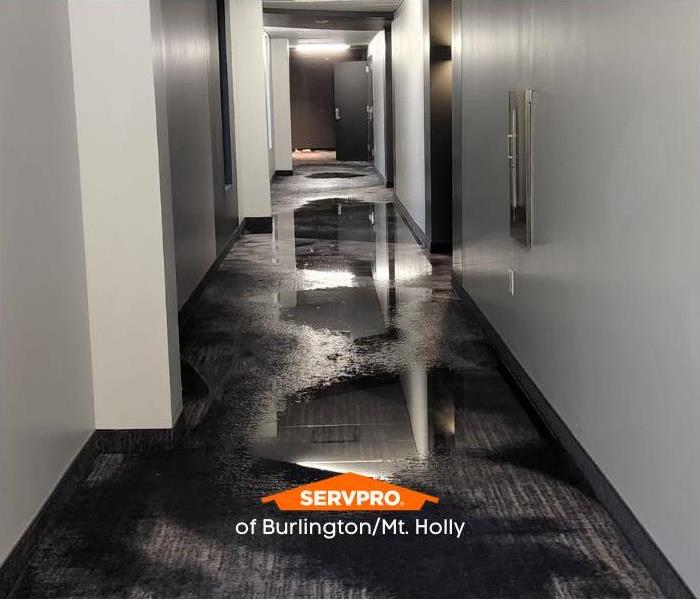 apartment hallway flooded by water heater